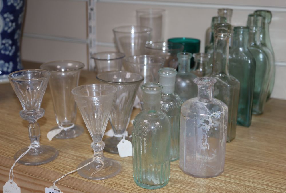 A quantity of glasses and glass bottles